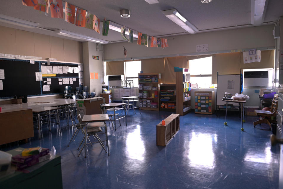 A classroom is empty with the lights off on what would otherwise be a blended learning school day on November 19, 2020 at Yung Wing School P.S. 124 in New York City.  / Credit: Michael Loccisano / Getty Images