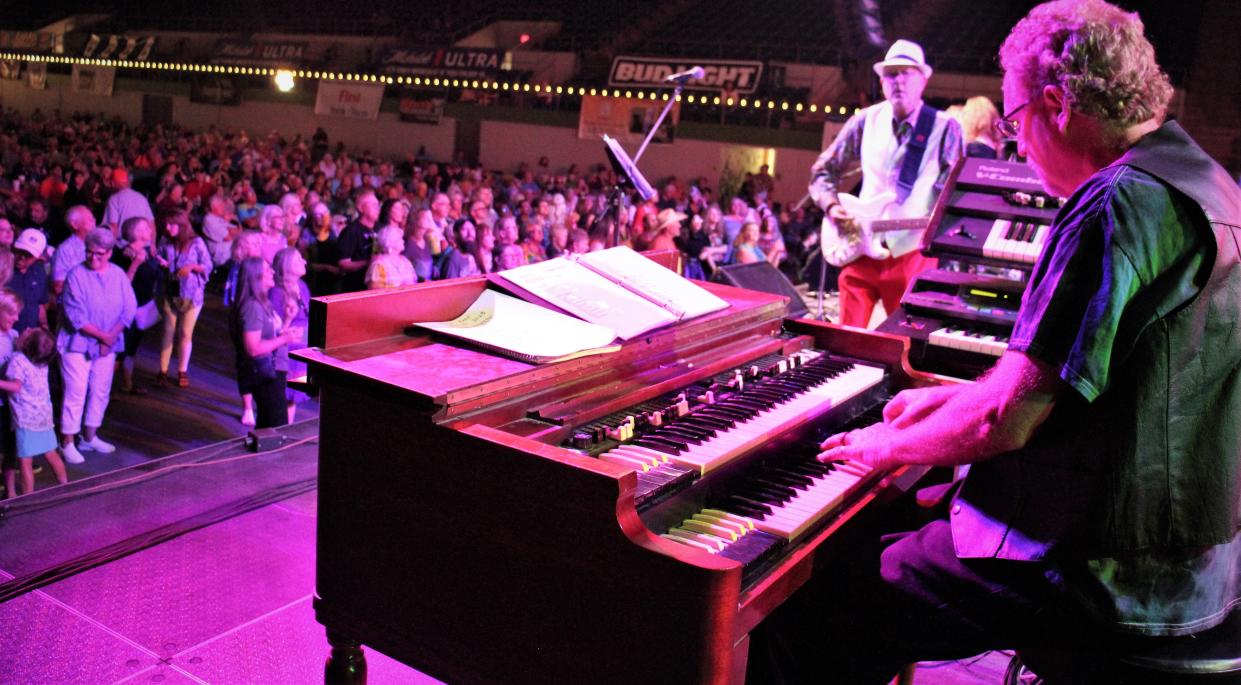Steve Couch, Abilene's go-to keyboardist for decades, plays as Terry Bettis and a large crowd looks on at Garageband Woodstock on Saturday at the Taylor County Coliseum.