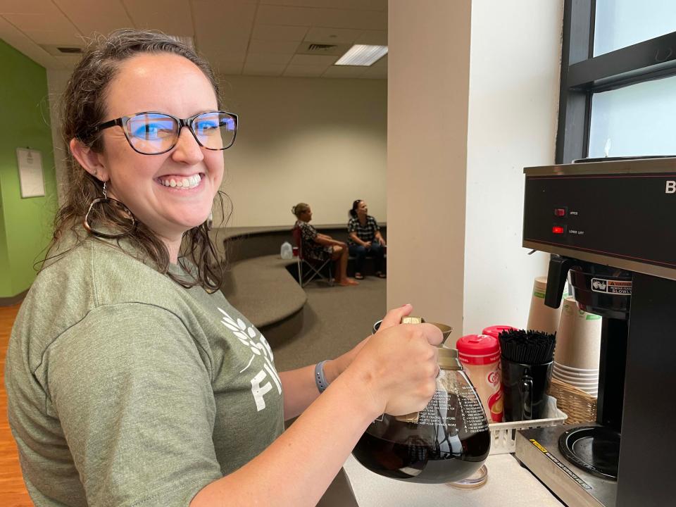 Director of Communications Ashley Cross pours coffee for clients of Fig Tree, a homeless community outreach program sponsored by Cokesbury United Methodist Church, on June 1, 2022.