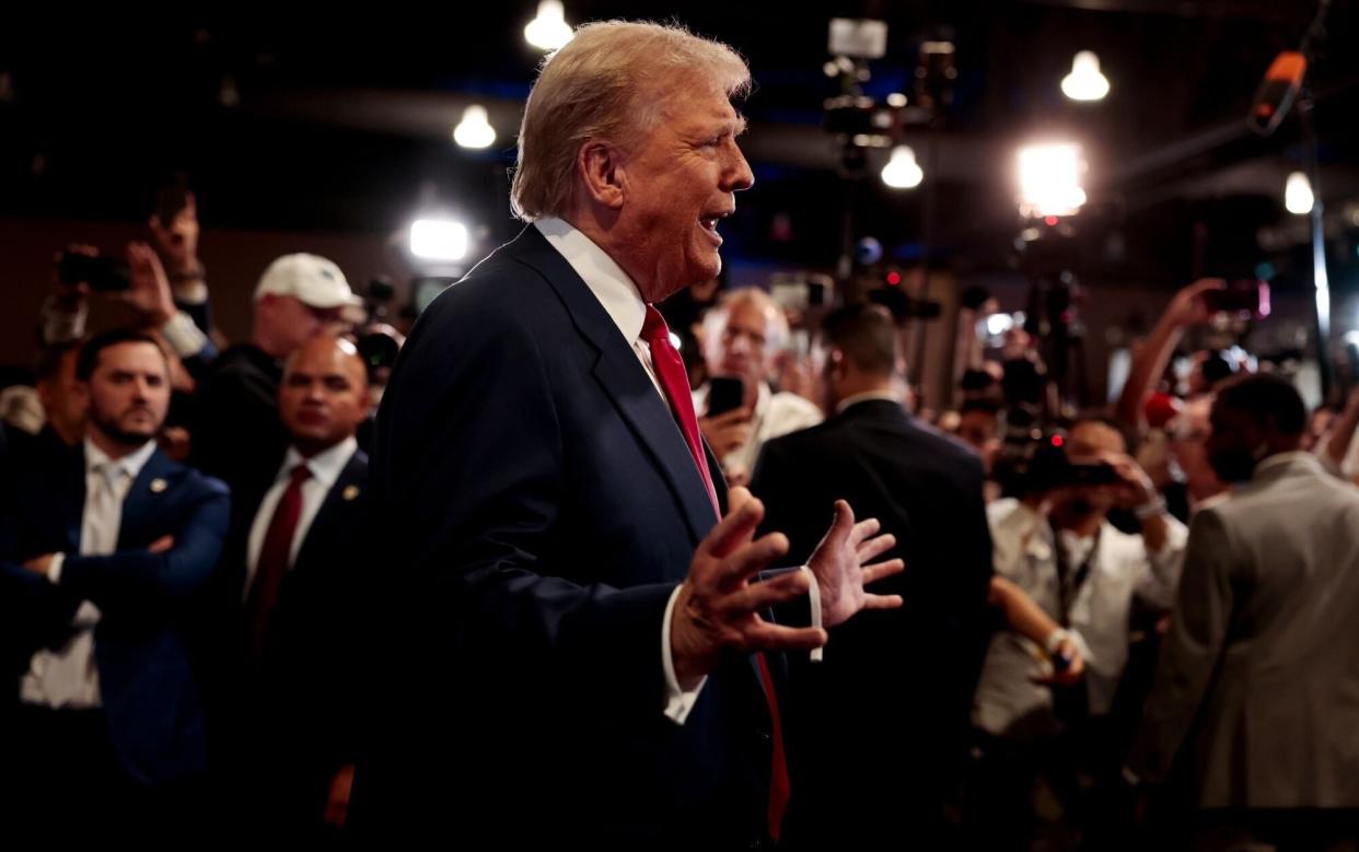 Former US President Donald Trump speaks to members of the media in the spin room following the second presidential debate at the Pennsylvania Convention Center