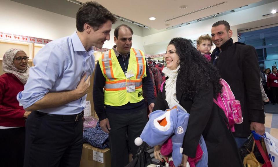 Canadian prime minister, Justin Trudeau, greets refugees fleeing from Syria in December 2015. 