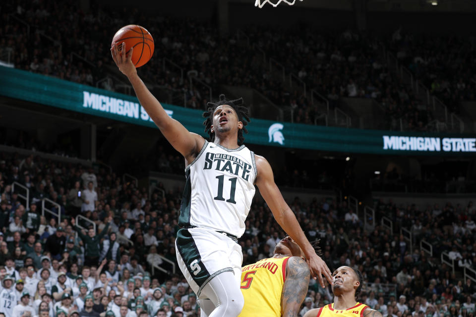 Michigan State guard A.J. Hoggard (11) goes up for a layup against Maryland guard DeShawn Harris-Smith (5) during the second half of an NCAA college basketball game, Saturday, Feb. 3, 2024, in East Lansing, Mich. (AP Photo/Al Goldis)