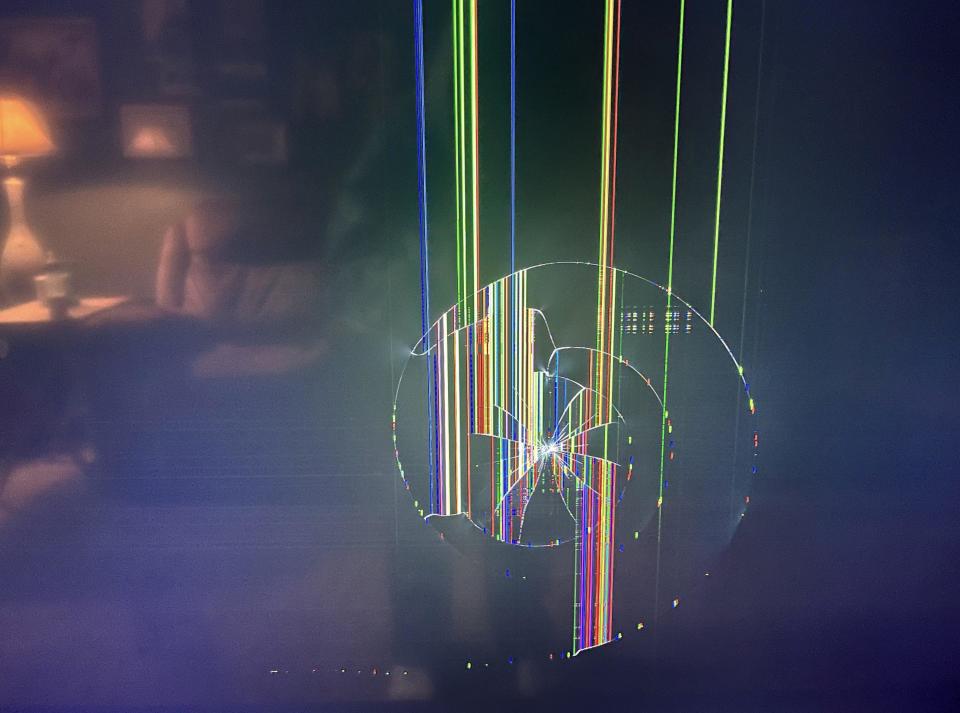 A broken screen with a spiral formation on it