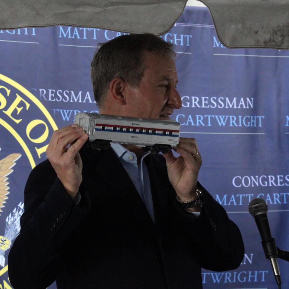 U.S. Rep. Matt Cartwright holds up a model Amtrak train car at a press conference in Scranton on Monday, Dec. 11, 2023.