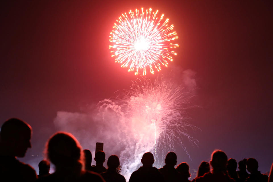 People watch fireworks over the Del Mar fair in San Diego County, California, on Tuesday.