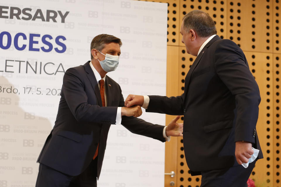 Slovenia's President Borut Pahor, left, welcomes Milorad Dodik, member of Bosnian Presidency, at the Brdo-Brijuni summit, in Brdo, Slovenia, Monday, May 17, 2021. The Brdo-Brijuni Process summit had originally been planned for last year, to coincide with the 10th anniversary of the initiative, but had been postponed twice due to the coronavirus pandemic. (AP Photo/Darko Bandic)