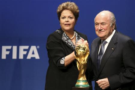 Brazil's President Dilma Rousseff (L) poses with FIFA President Sepp Blatter after delivering a statement at the FIFA headquarters in Zurich January 23, 2014. REUTERS/Thomas Hodel