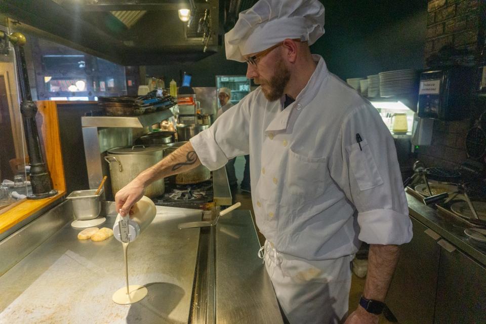 Chef Nathan Weik pours crepe batter on a cook top at Landmark Cafe & Creperie.

[WILLIAM WEAVER/FOR THE REGISTER-MAIL]