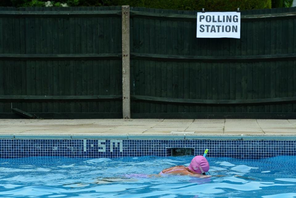 Voter Mrs Anne Whitman swims at Arundel Lido, set up as a polling station, in Arundel, southern England, on June 23, 2016.