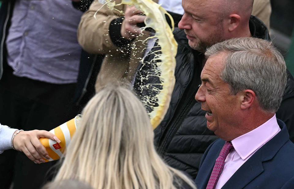 Newly appointed leader of Britain's right-wing populist party, Reform UK, and the party's parliamentary candidate for Clacton, Nigel Farage reacts as he is about to be hit in the face by the contents of a drinks cup, during his general election campaign launch in Clacton-on-Sea, eastern England, on June 4, 2024.