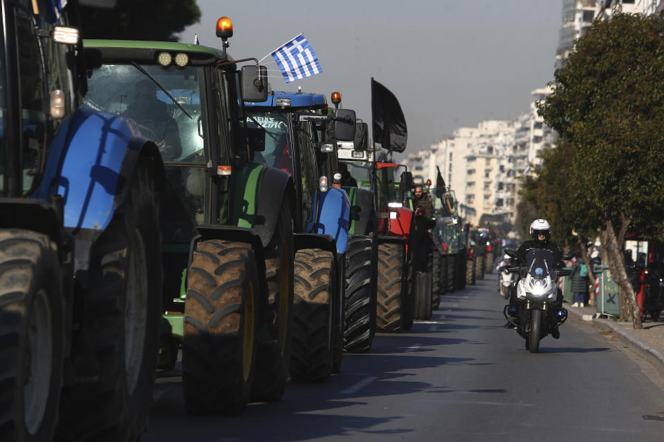 Protesting farmers with their tractors approach an agricultural fair during a rally in the port city of Thessaloniki, northern Greece, Thursday, Feb. 1, 2024. Greek farmers – hit by rising costs and crop damage caused by recent floods and wildfires – are threatening to block highways to press demands for tax relief and higher subsidy payments. (AP Photo/Giannis Papanikos)