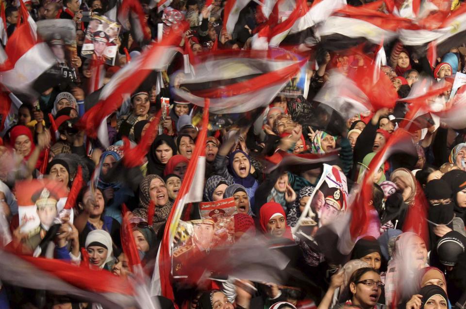 Supporters of Egypt's army and police gather at Tahrir square in Cairo, on the third anniversary of Egypt's uprising, January 25, 2014. Nine people were killed during anti-government marches on Saturday while thousands rallied in support of the army-led authorities, underlining Egypt's volatile political fissures three years after the fall of autocrat President Hosni Mubarak. Security forces lobbed teargas and some fired automatic weapons in the air to try to prevent demonstrators opposed to the government reaching Tahrir Square, the symbolic heart of the 2011 uprising that toppled the former air force commander. (REUTERS/Mohamed Abd El Ghany)