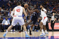 Orlando Magic center Bol Bol drives to the basket against Los Angeles Clippers center Ivica Zubac (40) and guard Paul George (13) during the first half of an NBA basketball game Wednesday, Dec. 7, 2022, in Orlando, Fla. (AP Photo/Scott Audette)