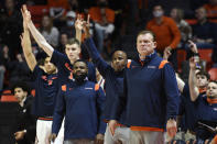 Illinois coach Brad Underwood surveys the court as the team bench celebrates during the first half of the team's NCAA college basketball game against Rutgers on Friday, Dec. 3, 2021, in Champaign, Ill. (AP Photo/Michael Allio)