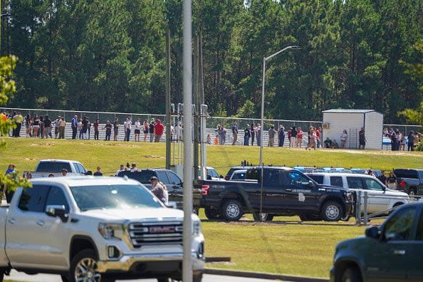 WINDER, GEORGIA - SEPTEMBER 4: Students and family members are line up nearby after a shooting at Apalachee High School on September 4, 2024 in Winder, Georgia. Four fatalities and multiple injuries have been reported, and a 14-year-old suspect is in custody according to authorities. (Photo by Megan Varner/Getty Images)