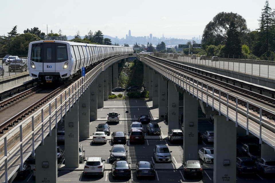 An eastbound Bay Area Rapid Transit train can be seen from the Rockridge station, Wednesday, June 7, 2023, in Oakland, Calif. BART has warned if the state doesn’t help out, it could force the agency to stop running after 9 p.m. and on weekends, while limiting regular service to just one train per hour. (AP Photo/Godofredo A. Vásquez)