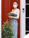 <p>Ariana Grande arrives at a friend's place with a box of donuts on Aug. 13 in L.A. </p>