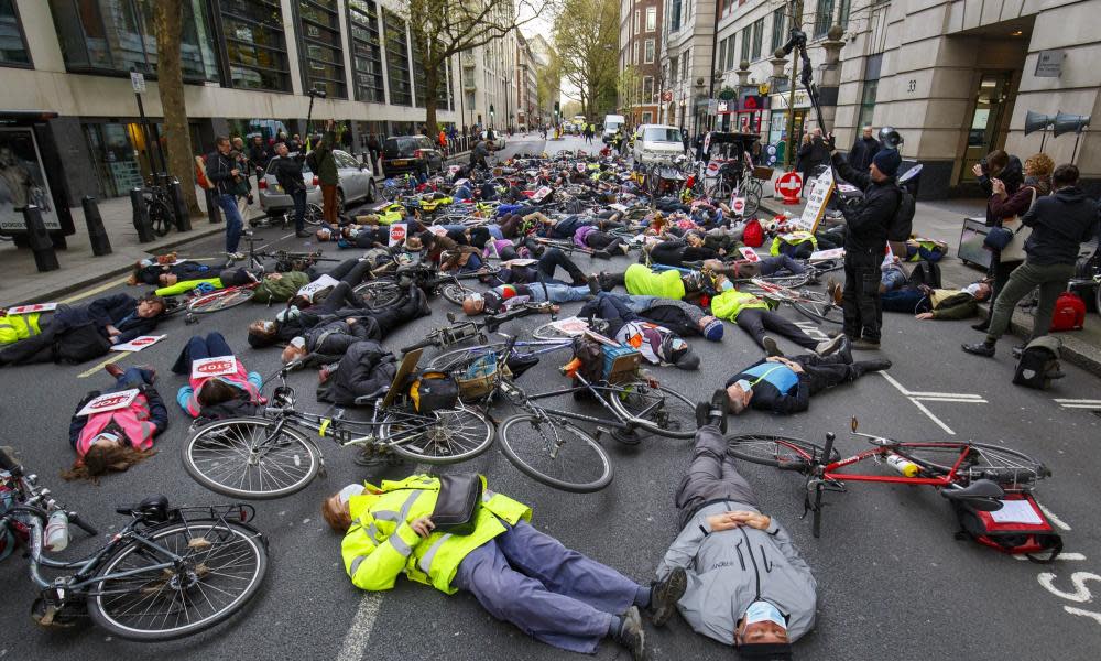 Cycling protesters stage a die-in at an anti-pollution rally in London