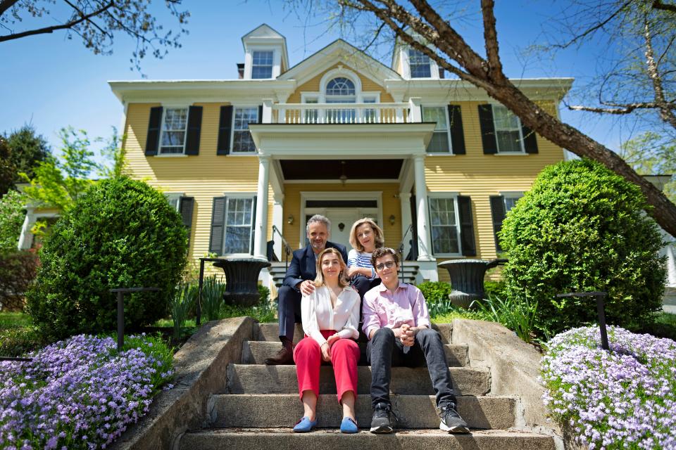 Cincinnati Symphony Orchestra music director Louis Langrée and his wife, Aimée, pose with their children, Antoine and Céleste, at Annwood Park in front of their home in East Walnut Hills in 2021.