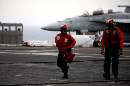 U.S. Navy sailors walk on the flight deck of the USS Harry S. Truman aircraft carrier in the eastern Mediterranean Sea, May 4, 2018. REUTERS/Alkis Konstantinidis