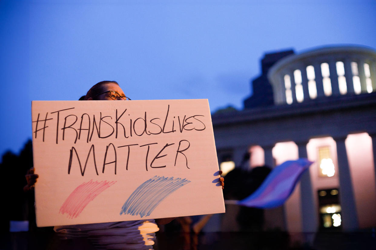 Transgender rights advocate holds a sign outside the Ohio Statehouse during the rally. Stephen Zenner/SOPA Images/LightRocket via Getty Images