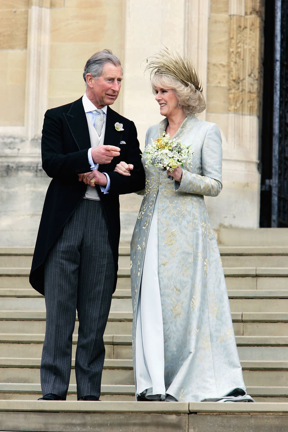 <p>Camilla, Duchess of Cornwall, wore a blue-gold dress coat by Robinson Valentine, which was inspired by her mother's jewelry, for her exchanging of vows with Prince Charles. She wore a headpiece by Philip Treacy. </p>