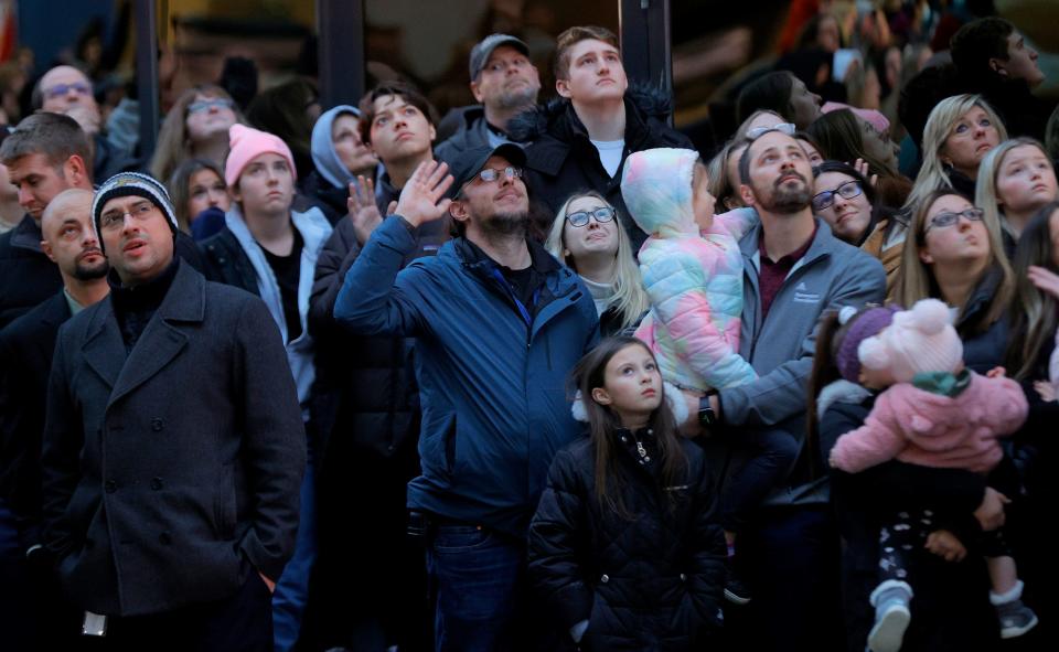 People gathered to honor the memory of Justin Shilling look up at the sky bridge to others who were waving at them at McLaren Oakland Hospital in Pontiac on Friday, Dec. 3, 2021. Shilling was one of four Oxford High School students shot and killed on Tuesday. He was actually declared legally dead and passed away on Wednesday. His parents decided to donate his organs to the Gift of Life.