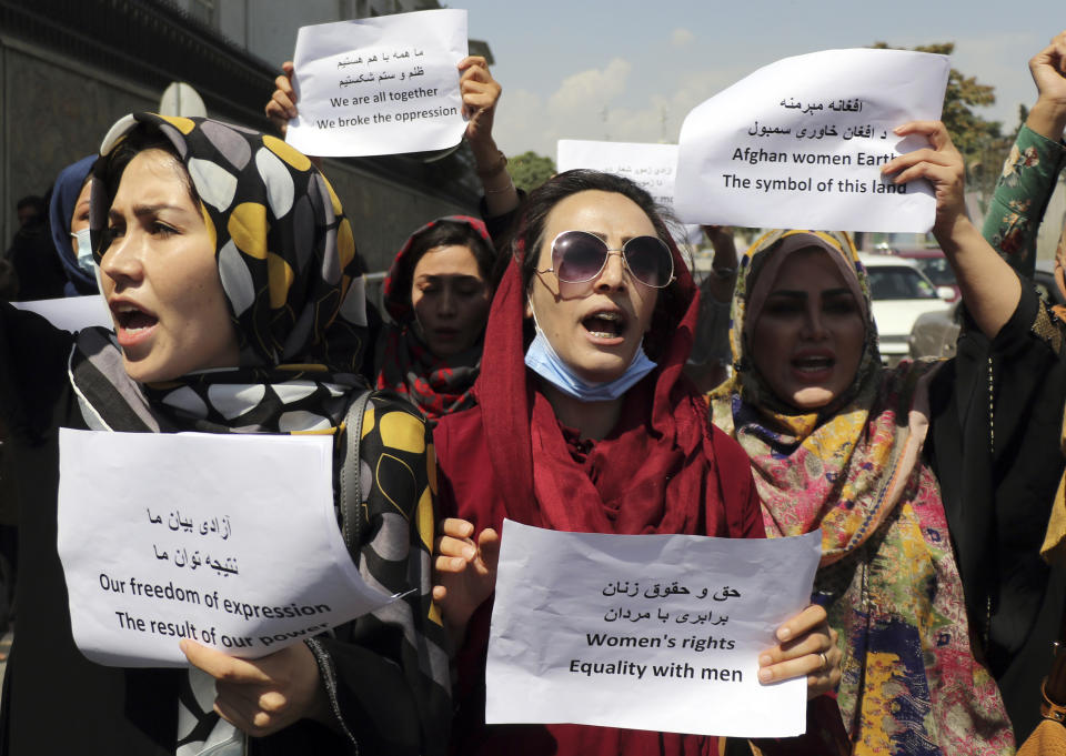 Women gather to demand their rights under the Taliban rule during a protest in Kabul, Afghanistan, Friday, Sept. 3, 2021. As the world watches intently for clues on how the Taliban will govern, their treatment of the media will be a key indicator, along with their policies toward women. When they ruled Afghanistan between 1996-2001, they enforced a harsh interpretation of Islam, barring girls and women from schools and public life, and brutally suppressing dissent. (AP Photo/Wali Sabawoon)