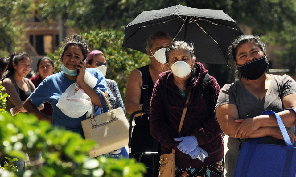 Orlando, US: Women wait in a queue to receive food aid provided by the Second Harvest Food Bank of Central Florida at the Calvario City Church. (Paul Hennessy/Echoes Wire/Barcroft Media via Getty Images)