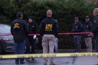 Law enforcement officers collect evidence near the scene of a shooting at the Boise Towne Square shopping mall in Boise, Idaho