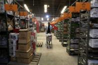 Worker of the Jumia company pushes a trolley cart between shelves in the warehouse in Lagos