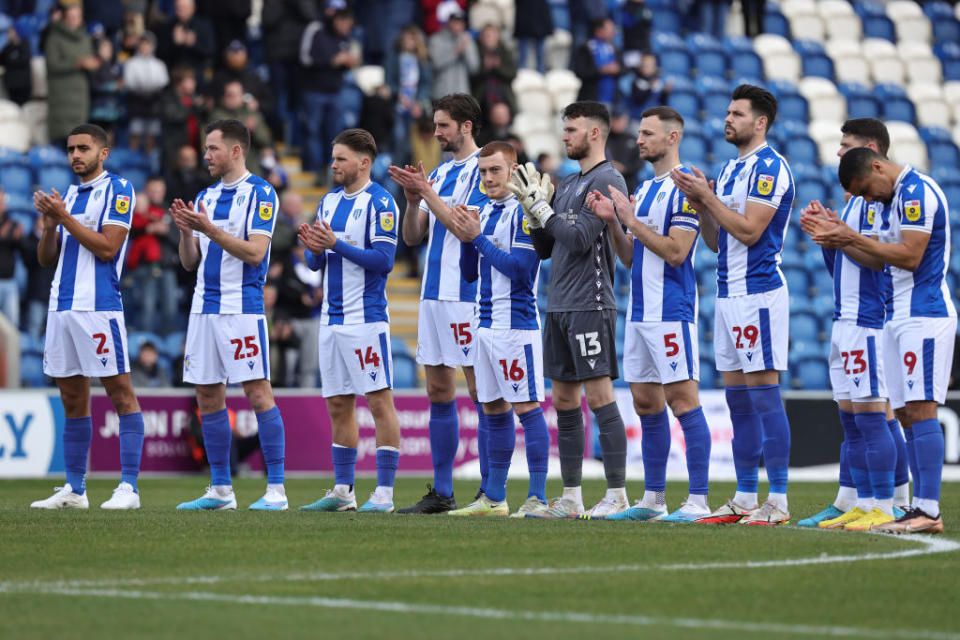 Colchester United season preview 2023/24 Colchester United players observe a minutes applause as a show of Solidarity on the one year anniversary of the conflict in Ukraine prior to the Sky Bet League Two between Colchester United and Northampton Town at JobServe Community Stadium on February 25, 2023 in Colchester, England. (Photo by Pete Norton/Getty Images)