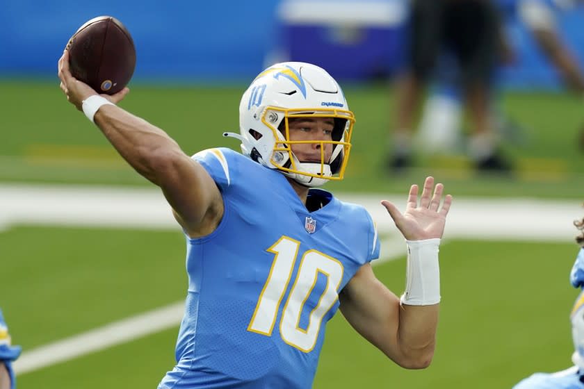 FILE - In this Sunday, Nov. 22, 2020, file photo, Los Angeles Chargers quarterback Justin Herbert throws a pass against the New York Jets during the first half of an NFL football game in Inglewood, Calif. Buffalo's Josh Allen and the AFC East-leading Bills prepare to host the rookie Justin Herbert-led Chargers on Sunday in a showdown of the NFL's two leaders in yards passing. (AP Photo/Jae C. Hong, File)