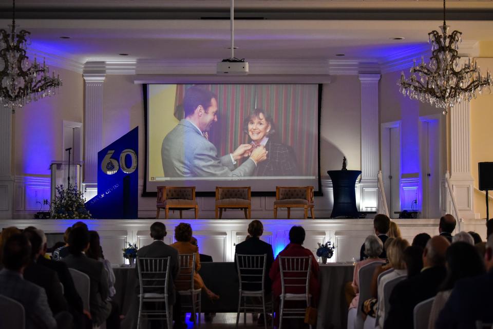 Guests at The Community Foundation for Northeast Florida's 60th anniversary event watch a video about civic engagement prize winner Delores Barr Weaver, a Jacksonville philanthropist.