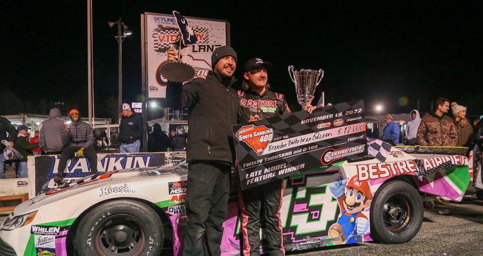 Brenden Queen, driver of the No. 03 BRC Late Model, celebrates in Victory Lane with team owner Lee Pulliam after winning the South Carolina 400 at Florence Motor Speedway on November 19, 2022. (Adam Fenwick/NASCAR)