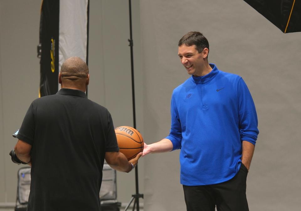 Head Coach Mark Daigneault hands the ball back to a photographer after finishing a session at Thunder Media Day, held in the Oklahoma City Convention Center on Monday, Oct. 2, 2023.