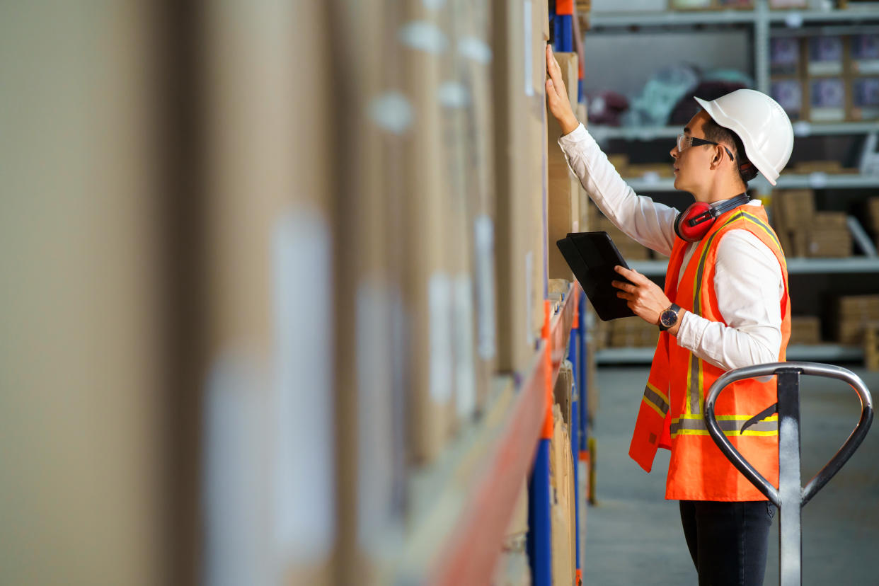 Employee of a logistics warehouse conducts an inventory of products