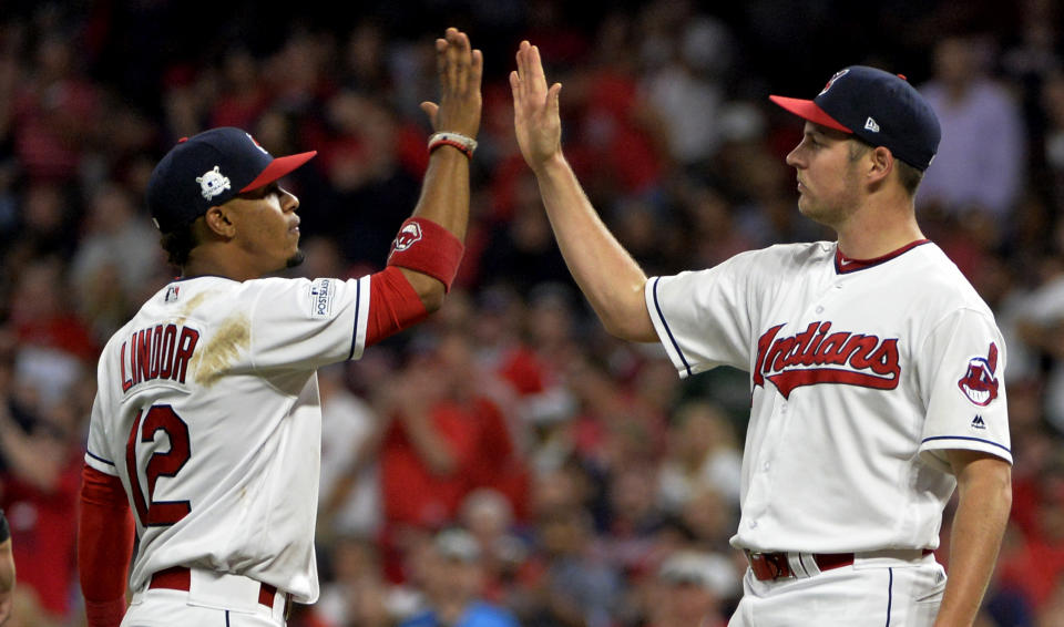 Trevor Bauer, right, gets congratulated by Francisco Lindor after his start in ALDS Game 1 against the Yankees. (AP)