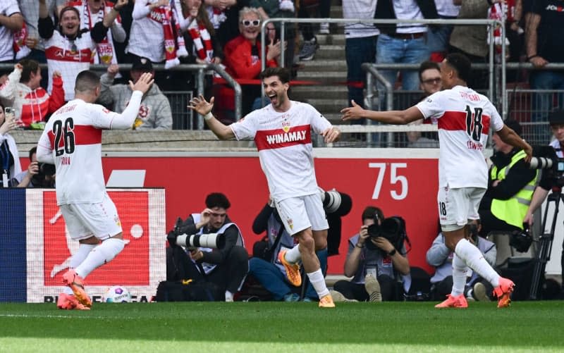 Stuttgart's Leonidas Stergiou celebrates scoring his side's first goal with team mates during the German Bundesliga soccer match between VfB Stuttgart and Bayern Munich at MHPArena. Bernd Weißbrod/dpa
