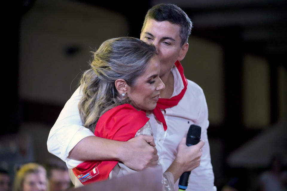 Santiago Peña, presidential candidate of the Colorado party, kisses his wife, Leticia Ocampos, during a political rally in Asuncion, Paraguay, Monday, April 24, 2023. Paraguay's general elections are scheduled for April 30. (AP Photo/Jorge Saenz)