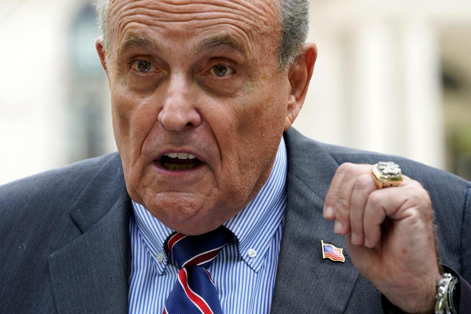 Rudy Giuliani speaks during a news conference June 7 in New York. He's expected to appear before a Georgia grand jury Tuesday in a fast-moving investigation of alleged interference in the 2020 election.