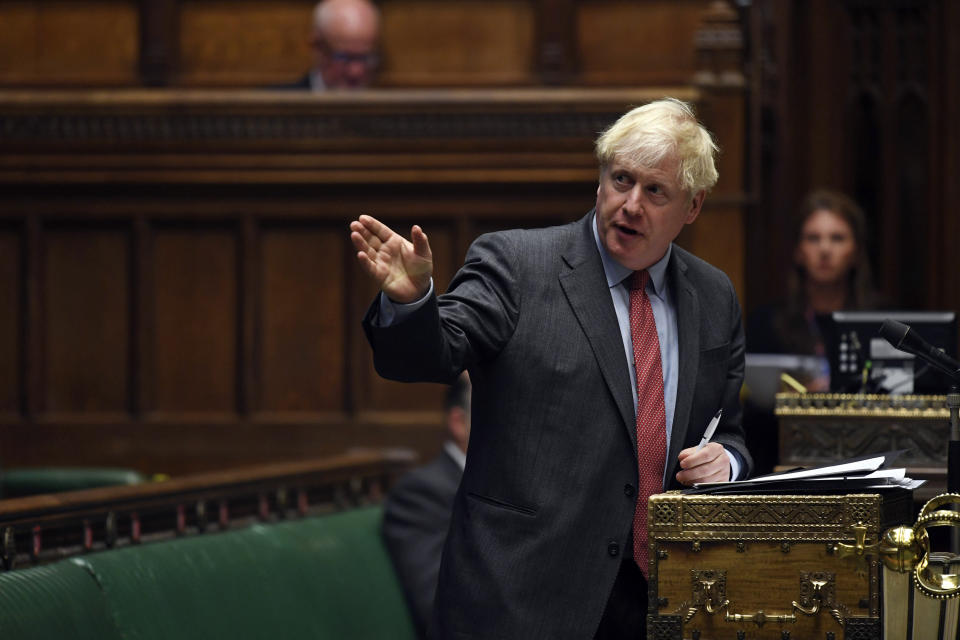 In this handout photo provided by UK Parliament, Britain's Prime Minister Boris Johnson delivers a statement in the House of Commons, London, Tuesday, Sept. 22, 2020. Johnson has warned Britons they should not expect to return to a normal social or work life for at least six months, as he announced new restrictions he hopes will suppress a surge in coronavirus cases. (Jessica Taylor/UK Parliament via AP)