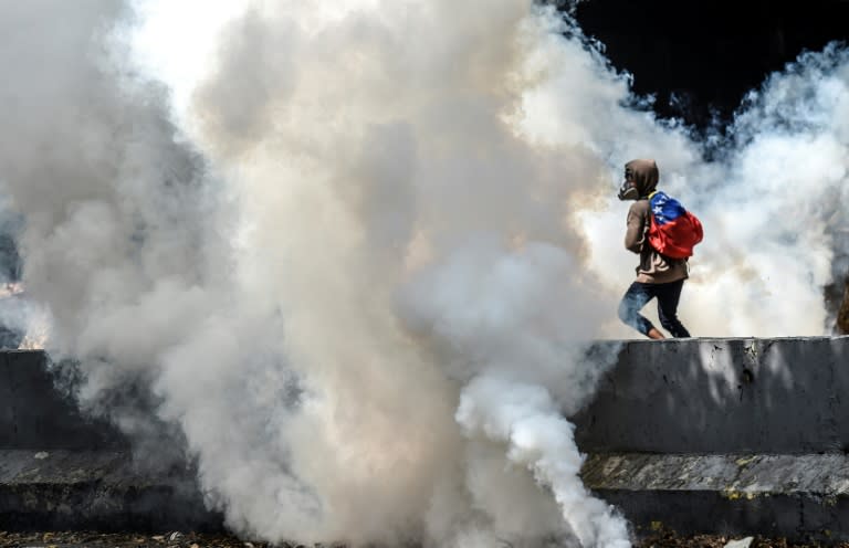 Venezuelan opposition activists clash with police forces during a demonstration against President Nicolas Maduro in Caracas