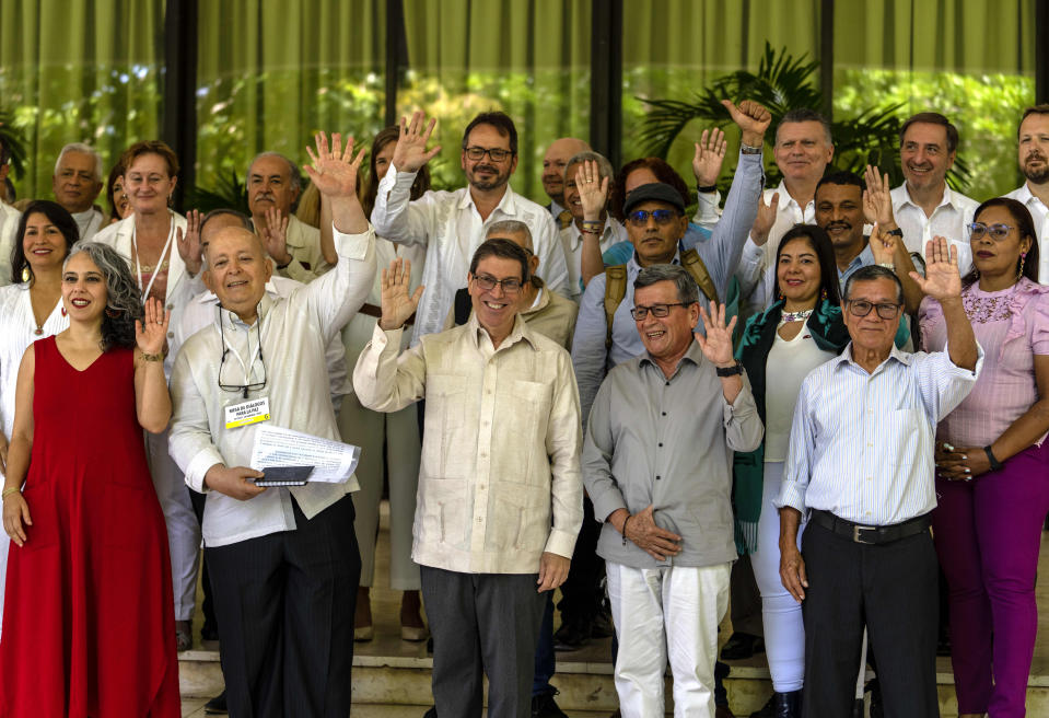 Government representatives and members of the Colombian National Liberation Army (ELN) pose for a photo at the inauguration of the third cycle of peace negotiations between the guerrilla group and the Colombian government in Havana, Cuba, Tuesday, May 2, 2023. From left, front row, are Colombian Senator Maria Jose Pizarro, chief negotiator for the Colombian government Jose Otty Patiño, Cuban Foreign Affairs Minister Bruno Rodriguez, former chief of the ELN Nicolás Rodríguez Bautista, alias "Gabino," and ELN Commander Pablo Beltran. (AP Photo/Ramon Espinosa)