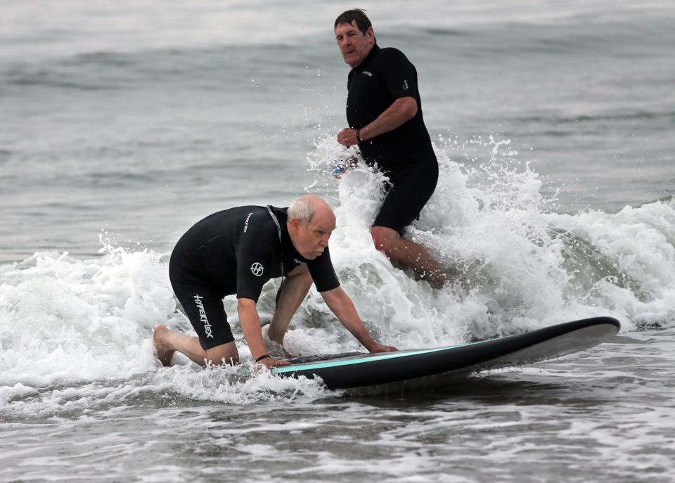 The Wounded Warrior Project returned to Hampton's North Beach for its 14th Hit The Beach Friday, Aug. 26, 2022. Veteran Ed Hiller has a successful ride as he balances on the board.