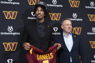 Washington Commanders irst round draft pick Jayden Daniels, left, holds his jersey with controlling owner Josh Harris, right, following an NFL football news conference in Ashburn, Va., Friday, April 26, 2024. (AP Photo/Manuel Balce Ceneta)
