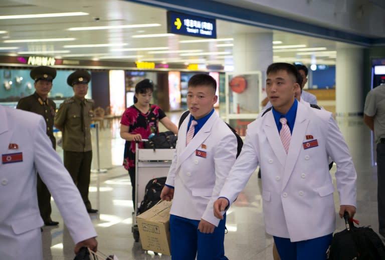 Members of North Korea's delegation for the 2016 Games arrive for their departure from Pyongyang International Airport to Brazil on July 26, 2016