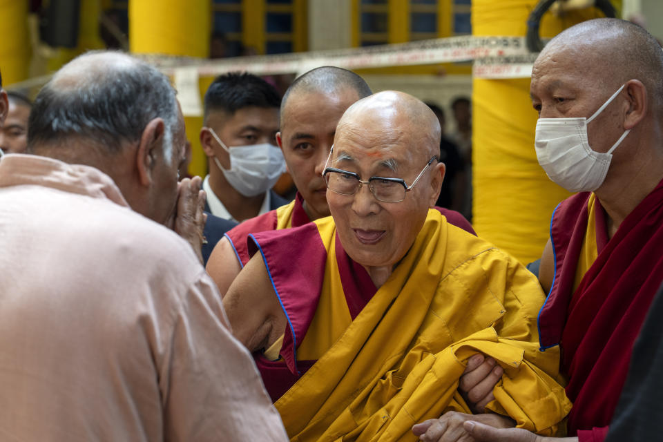 FILE- Tibetan spiritual leader the Dalai Lama greets a guest as he leaves after attending a special event during which exile Tibetans made him traditional offerings and prayed for his long life, at the Tsuglakhang temple in Dharamshala, India, June 11, 2024. A bipartisan U.S. congressional delegation met with the Dalai Lama at his residence in India’s Dharamshala on Wednesday, in a visit that China has criticized as it views the exiled leader as dangerous separatist. (AP Photo/Ashwini Bhatia, File)