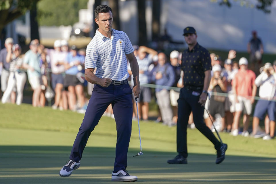 Billy Horschel celebrates his putt on the 16th green during their fourball match at the Presidents Cup golf tournament at the Quail Hollow Club, Friday, Sept. 23, 2022, in Charlotte, N.C. (AP Photo/Julio Cortez)