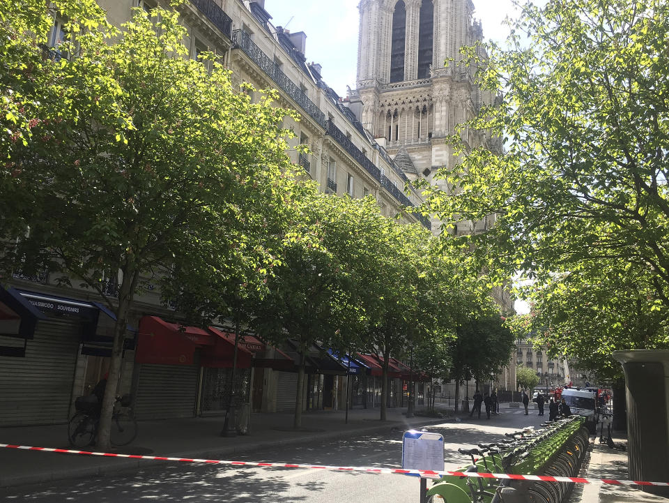 The streets around Notre Dame cathedral are cordoned off in Paris, Thursday, April 18, 2019. Since Monday's fire, half the island in the middle of the Seine has been closed to visitors. Residents who had never met before suddenly find themselves the only customers of restaurants and cafés normally filled with tourists. (AP Photo/Nicolas Vaux-Montagny)